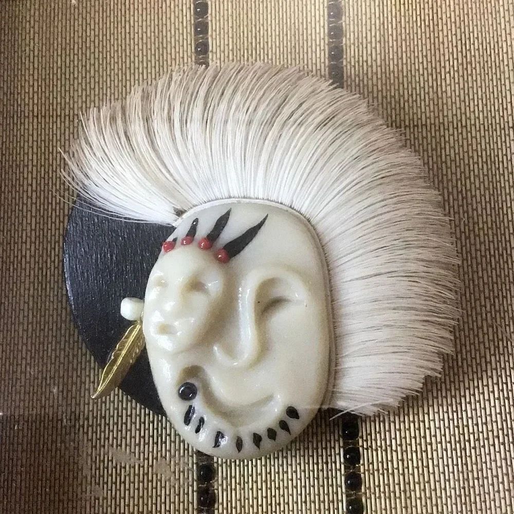 Framed vintage American Indian/Eskimo, and carved natural material brooch 